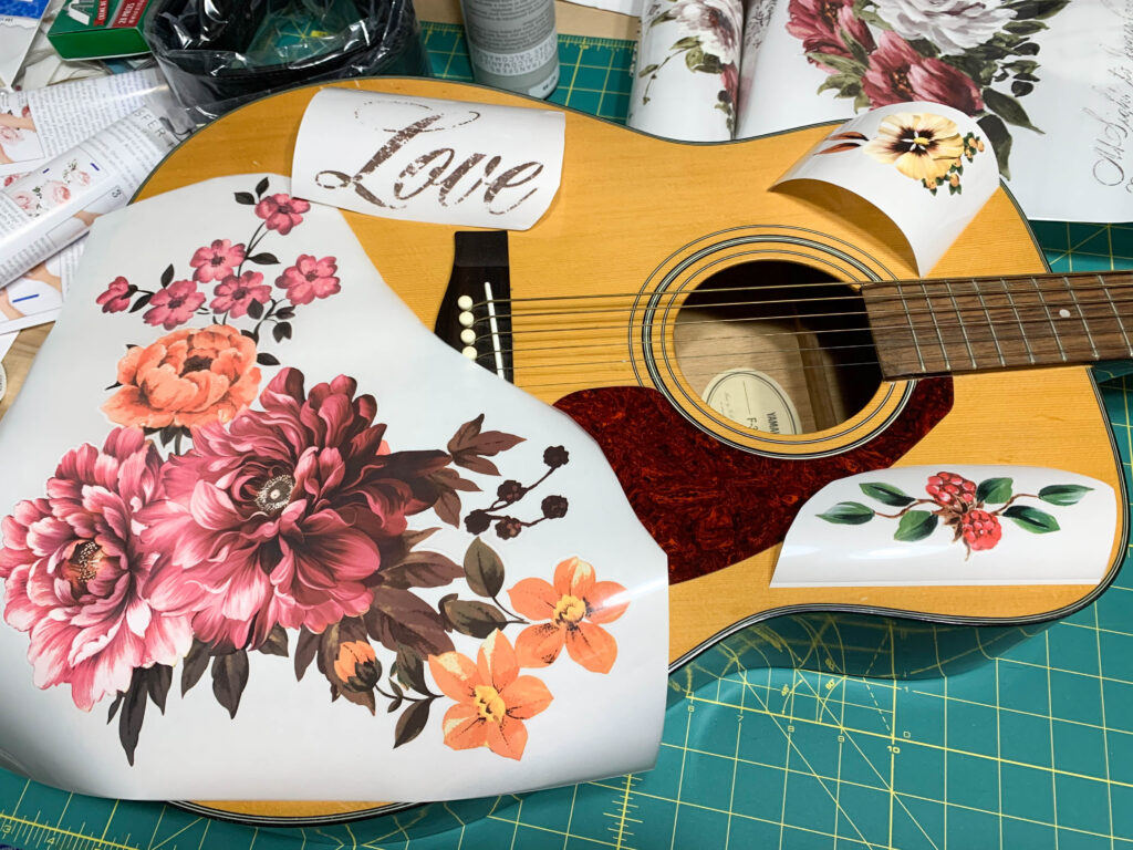 Redesign with Prima transfers laid out on an old guitar