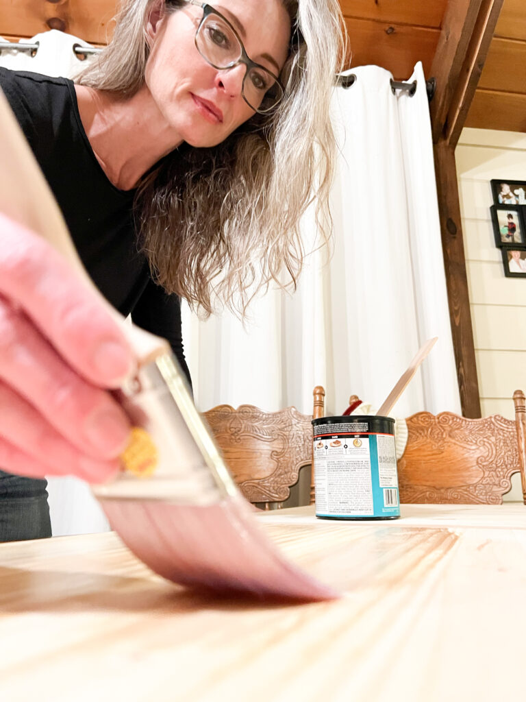Stephanie Ray applies Minx Polycrylic to wood desk top
