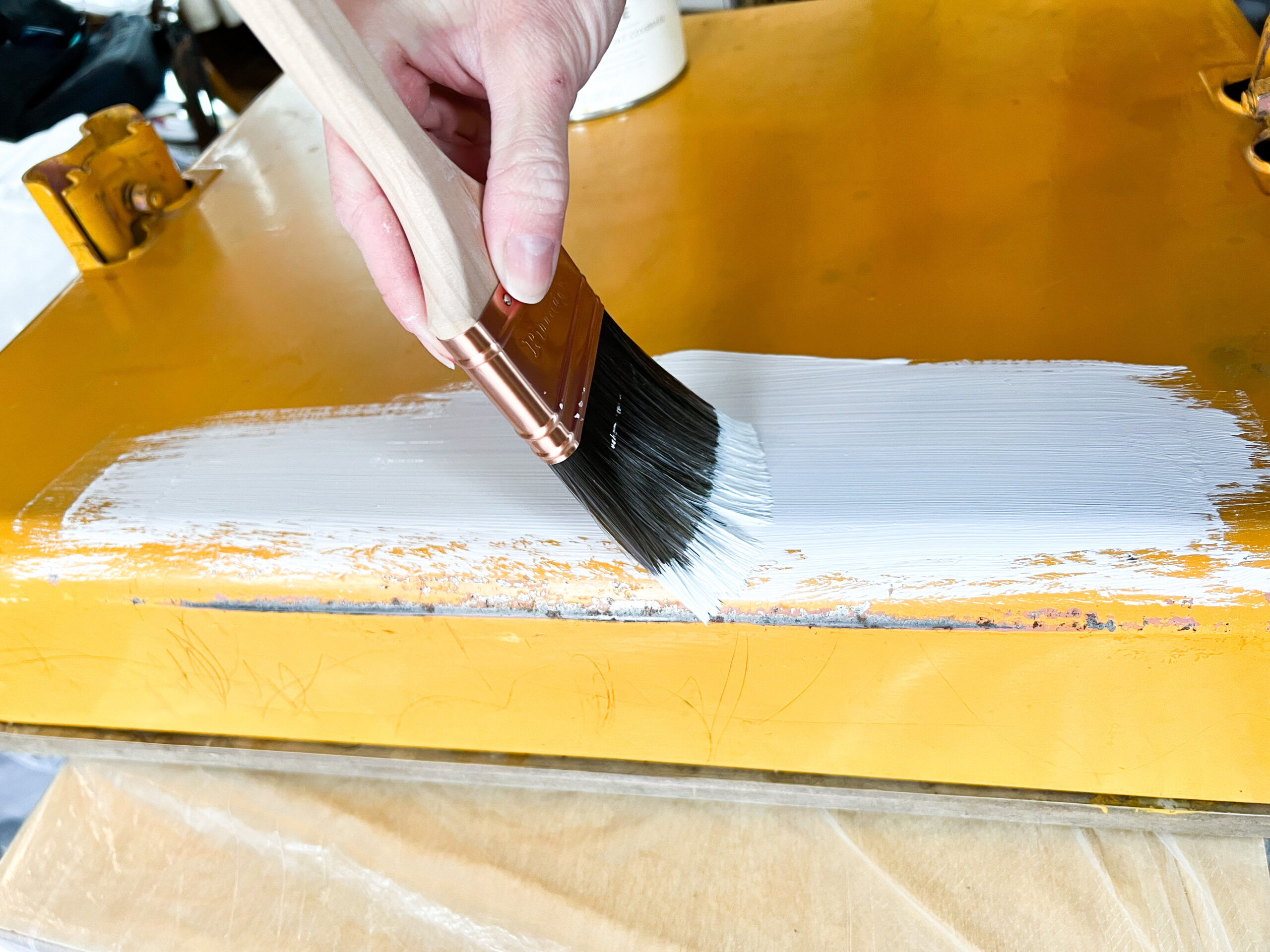 Stephanie Ray painting an Old metal school desk